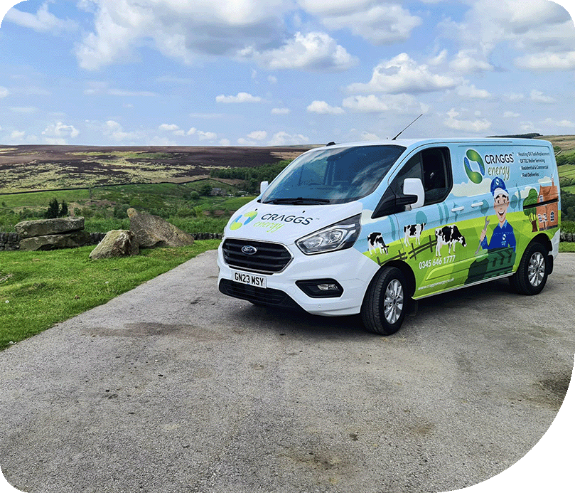 Craggs Energy braded boiler service van parked up with green hills and a blue cloudy sky.